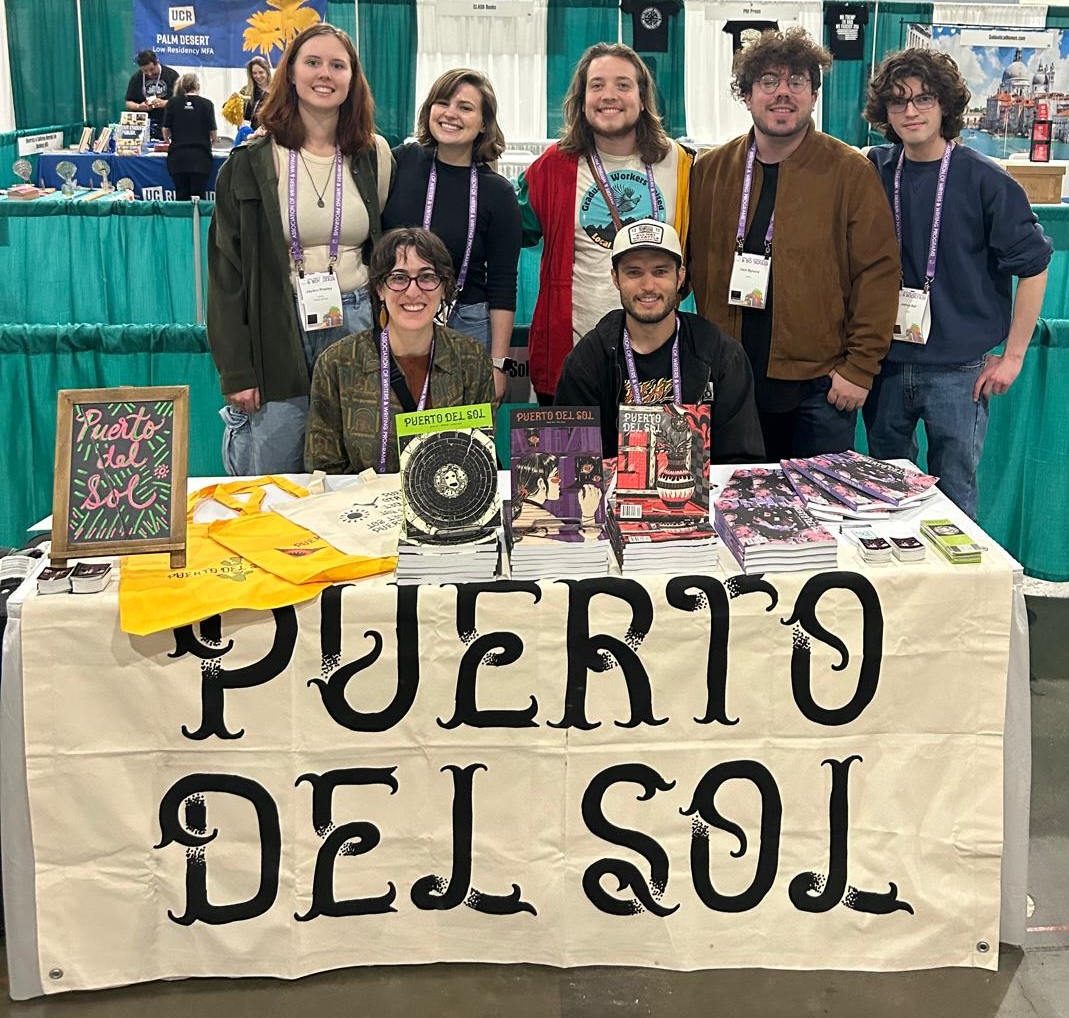 Photograph of several puerto del sol editors at their booth at the AWP conference